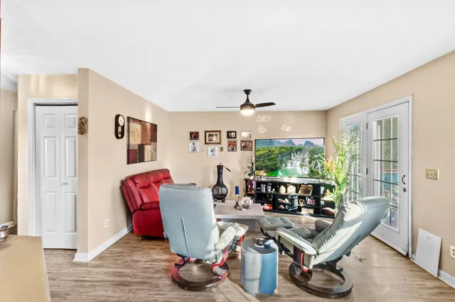 a living room with furniture a window and wooden floor