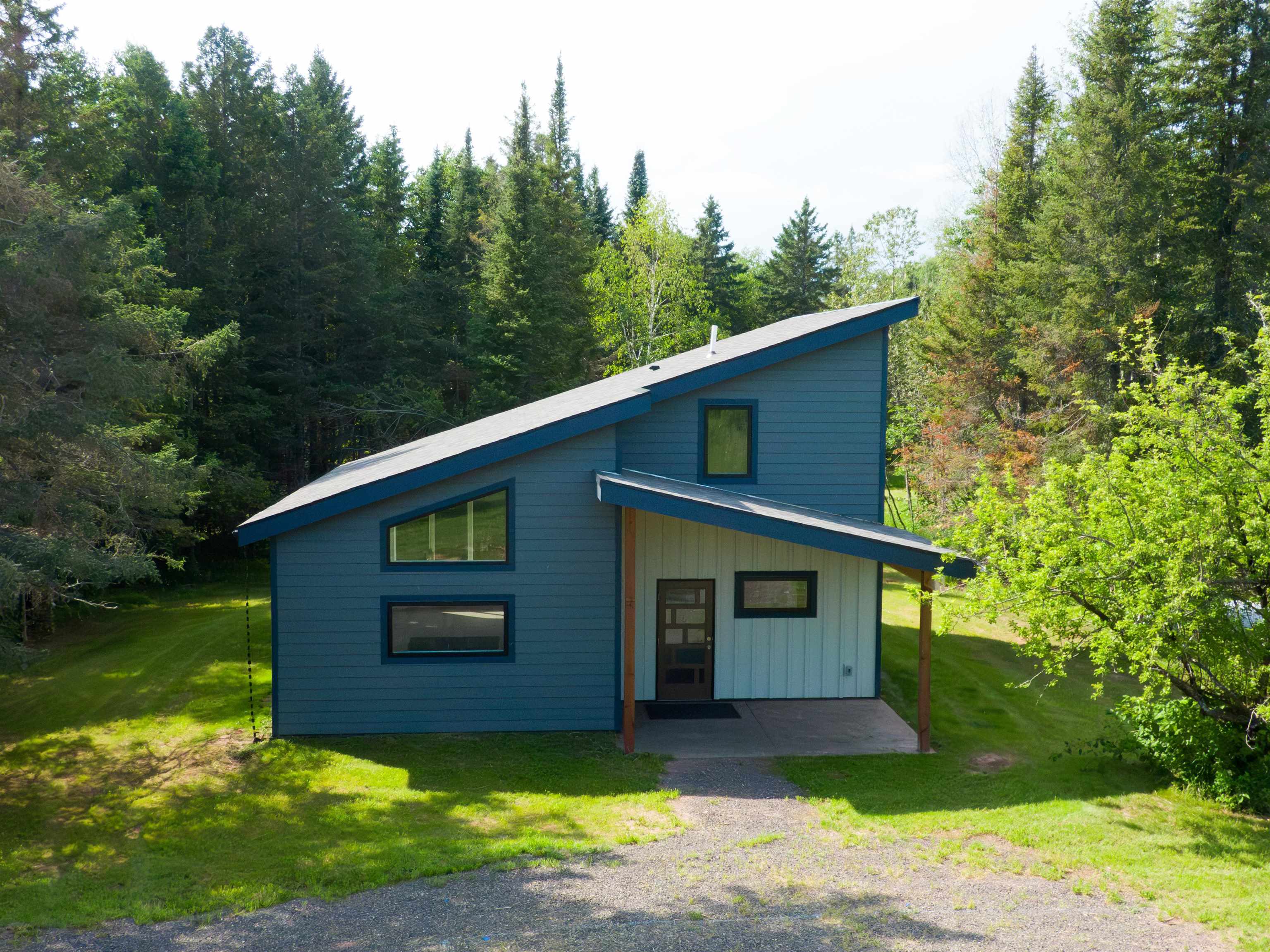 23190 Sawgrass Road Cornucopia, WI 54827 - Photo 3 of 23 View of front of house with a front lawn