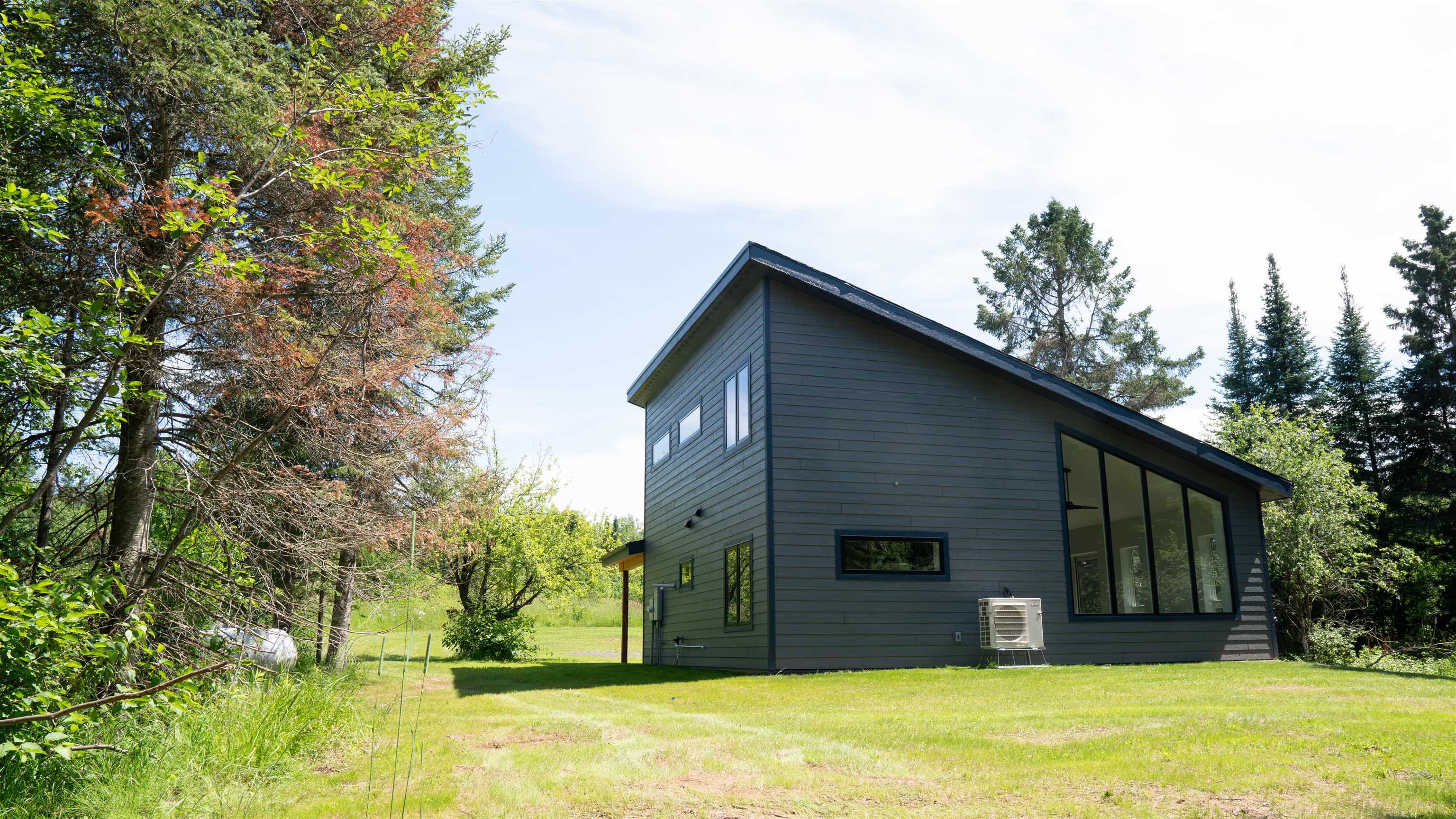 23190 Sawgrass Road Cornucopia, WI 54827 - Photo 5 of 23 View of property exterior featuring a yard