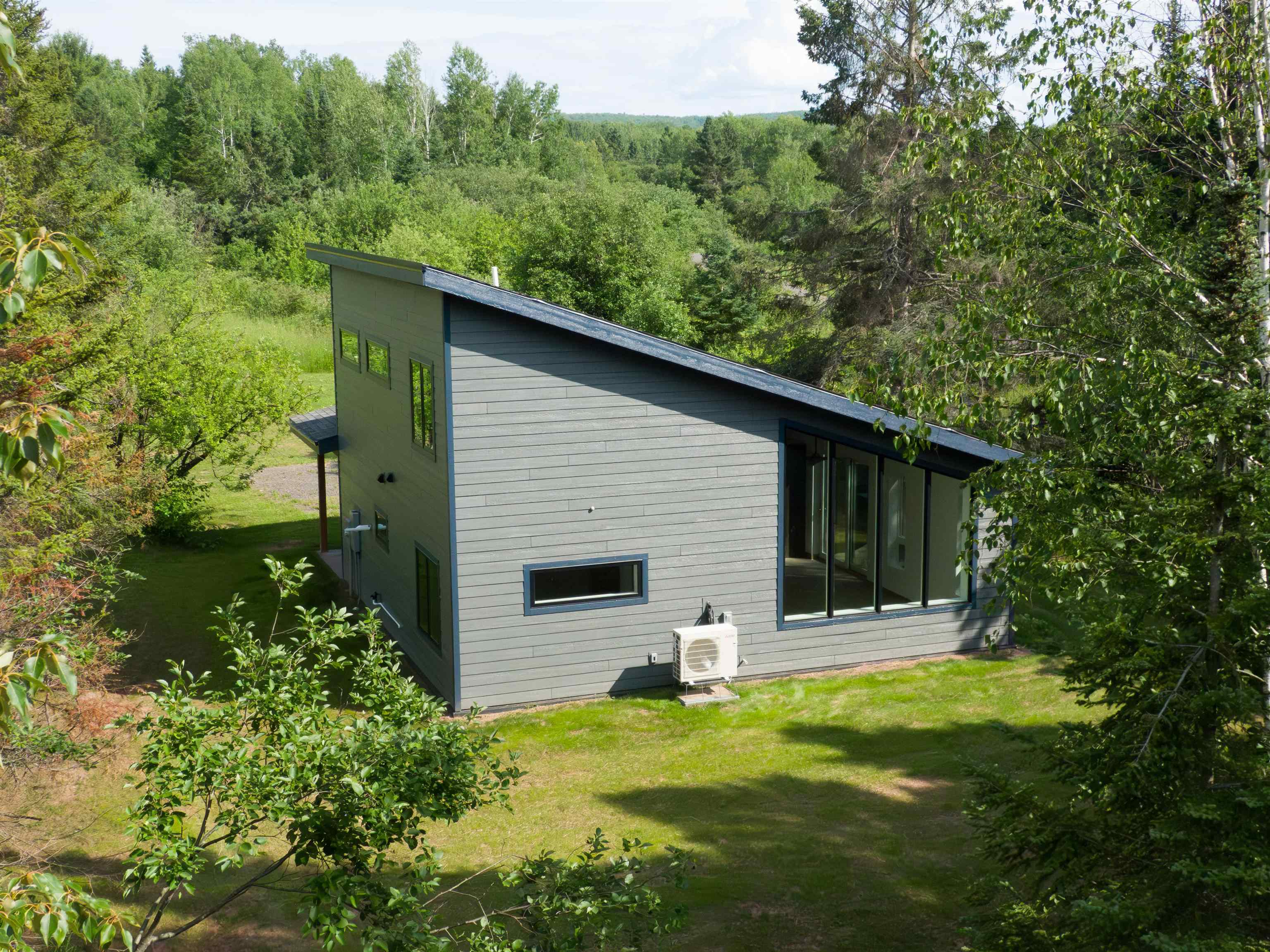 23190 Sawgrass Road Cornucopia, WI 54827 - Photo 6 of 23 Back of house with a yard