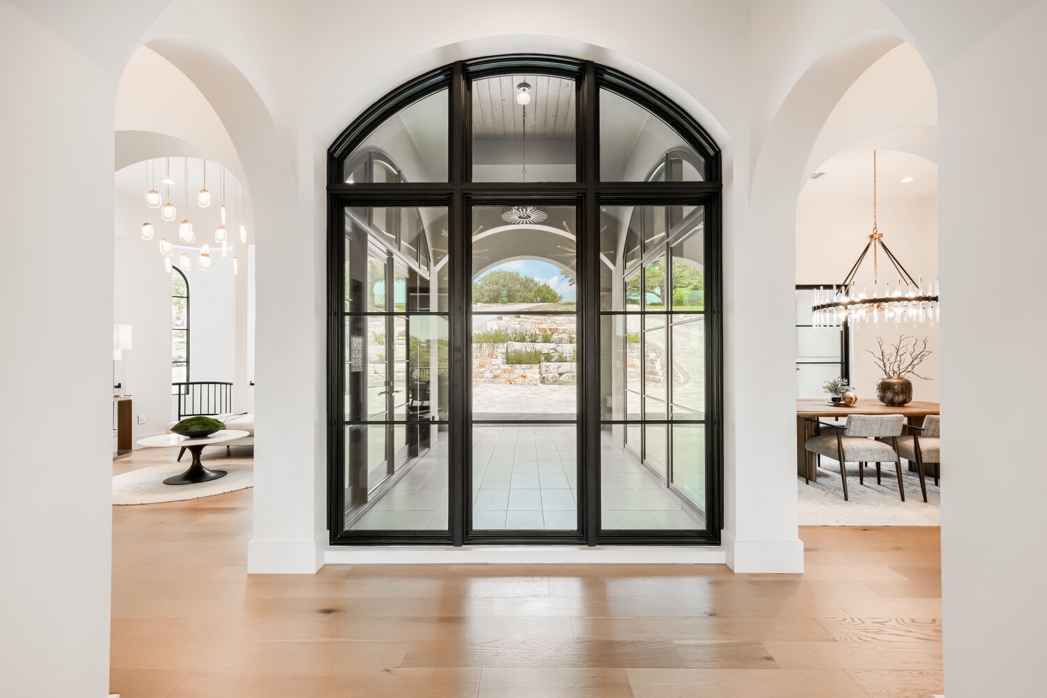 8132 Magnolia Ridge Cove Austin, TX 78738 - Photo 12 of 38 Grand arched entryways and a dramatic glass door welcome you into this light-filled home.