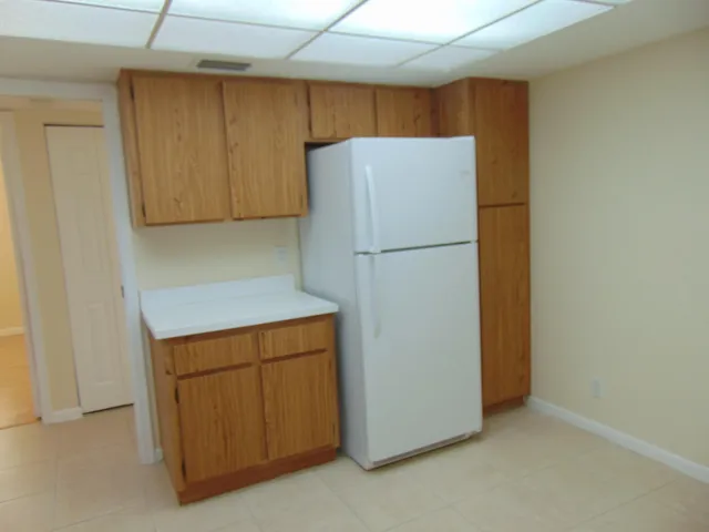 a white refrigerator freezer sitting in a kitchen