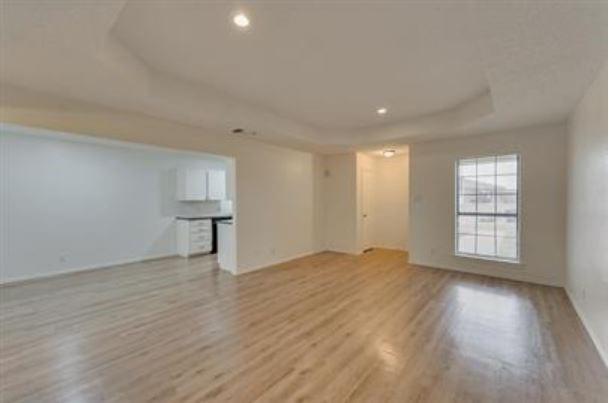 1817 San Rafael Street, Unit 1 Fort Worth, TX 76134 - Photo 3 of 15 a view of an empty room with wooden floor and a window