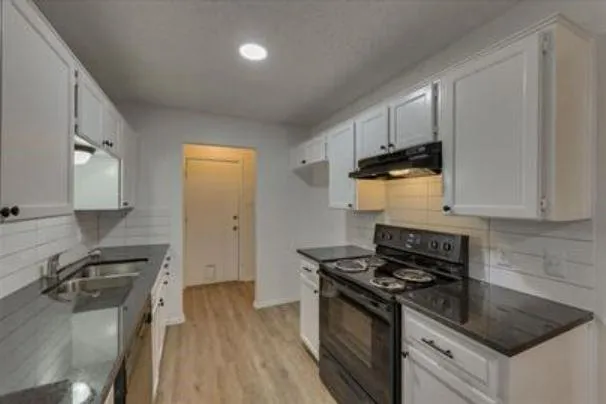 a kitchen that has a sink and a stove