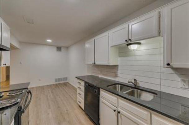 1817 San Rafael Street, Unit 1 Fort Worth, TX 76134 - Photo 6 of 15 a kitchen that has a sink and a stove