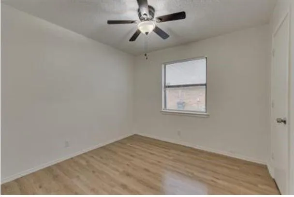 a view of an empty room with a fan