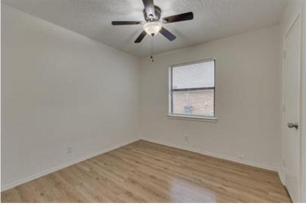 1817 San Rafael Street, Unit 1 Fort Worth, TX 76134 - Photo 9 of 15 an empty room with a window and a ceiling fan