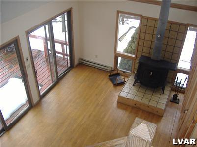 952 Canterbury Road Bushkill, PA 18324 - Photo 2 of 11 a living room with furniture and a floor to ceiling window