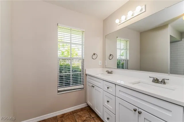 a bathroom with a sink double vanity and a shower