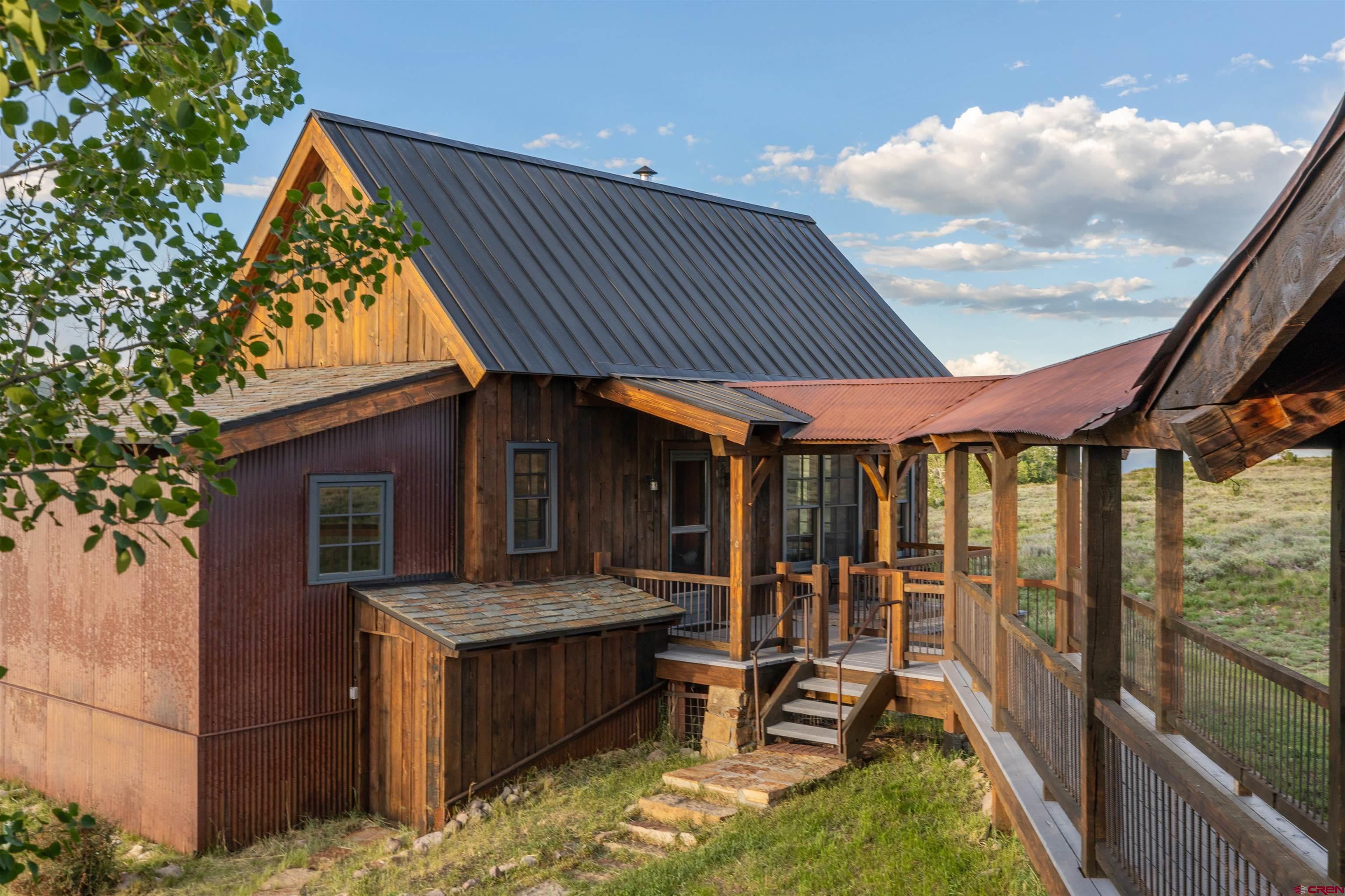 842 Ranch Road Ridgway, CO 81432 - Photo 18 of 35 a backyard of a house with a fountain swing table and chairs