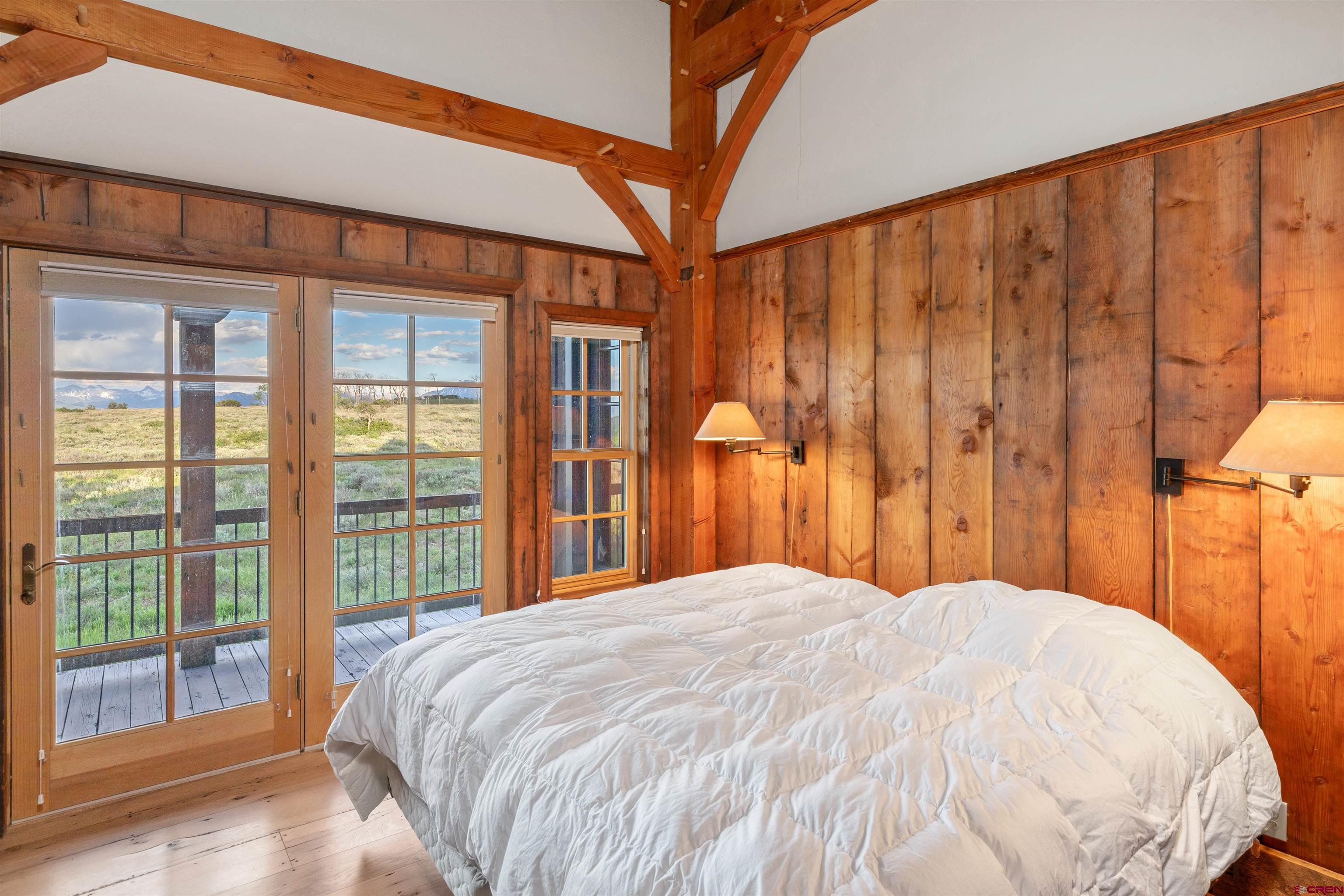 842 Ranch Road Ridgway, CO 81432 - Photo 21 of 35 a large bed sitting in a bedroom next to a window