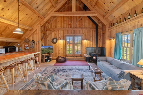 a dining room with furniture a chandelier and wooden floor