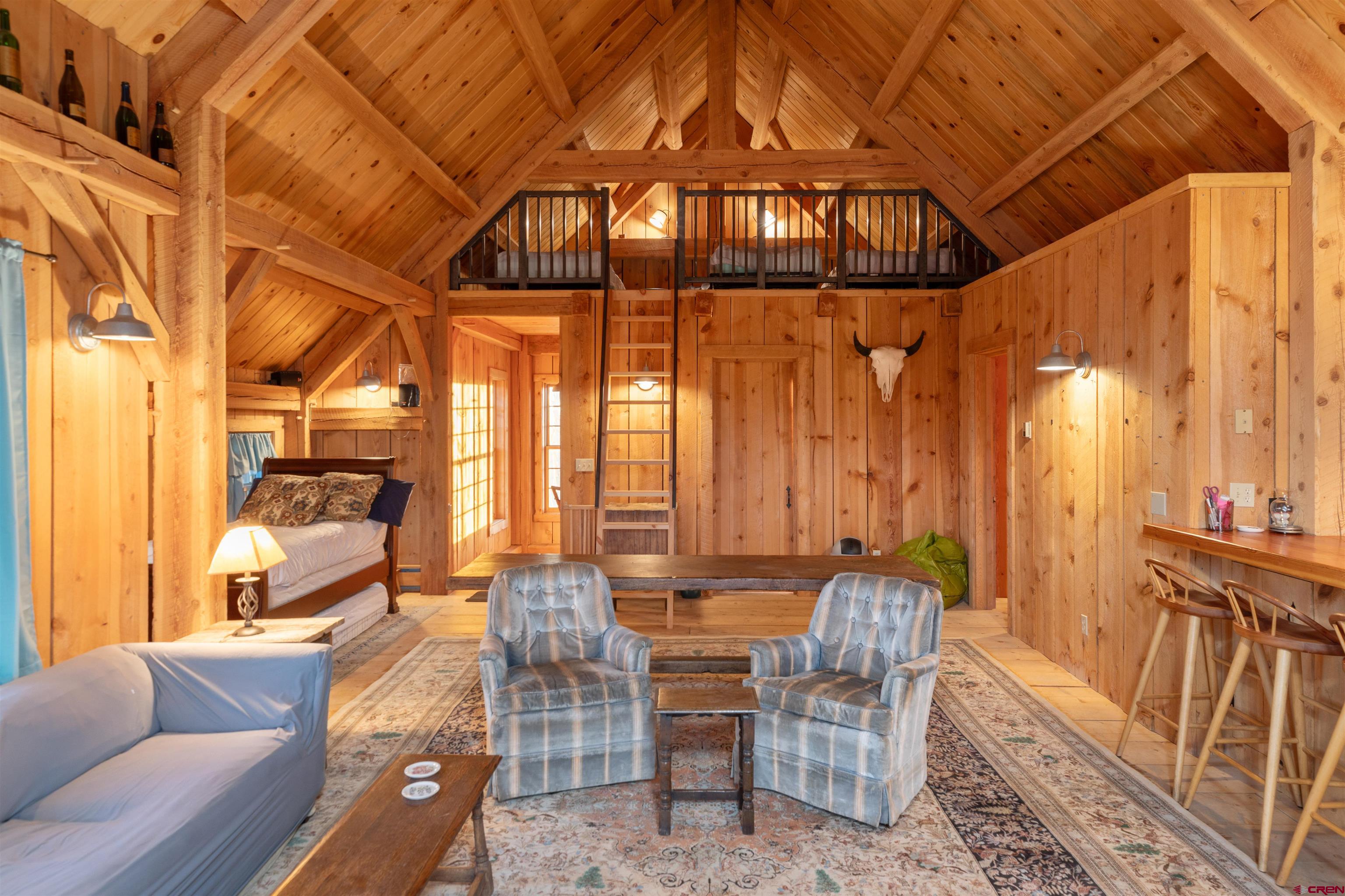 842 Ranch Road Ridgway, CO 81432 - Photo 25 of 35 a dining room with furniture a chandelier and wooden floor