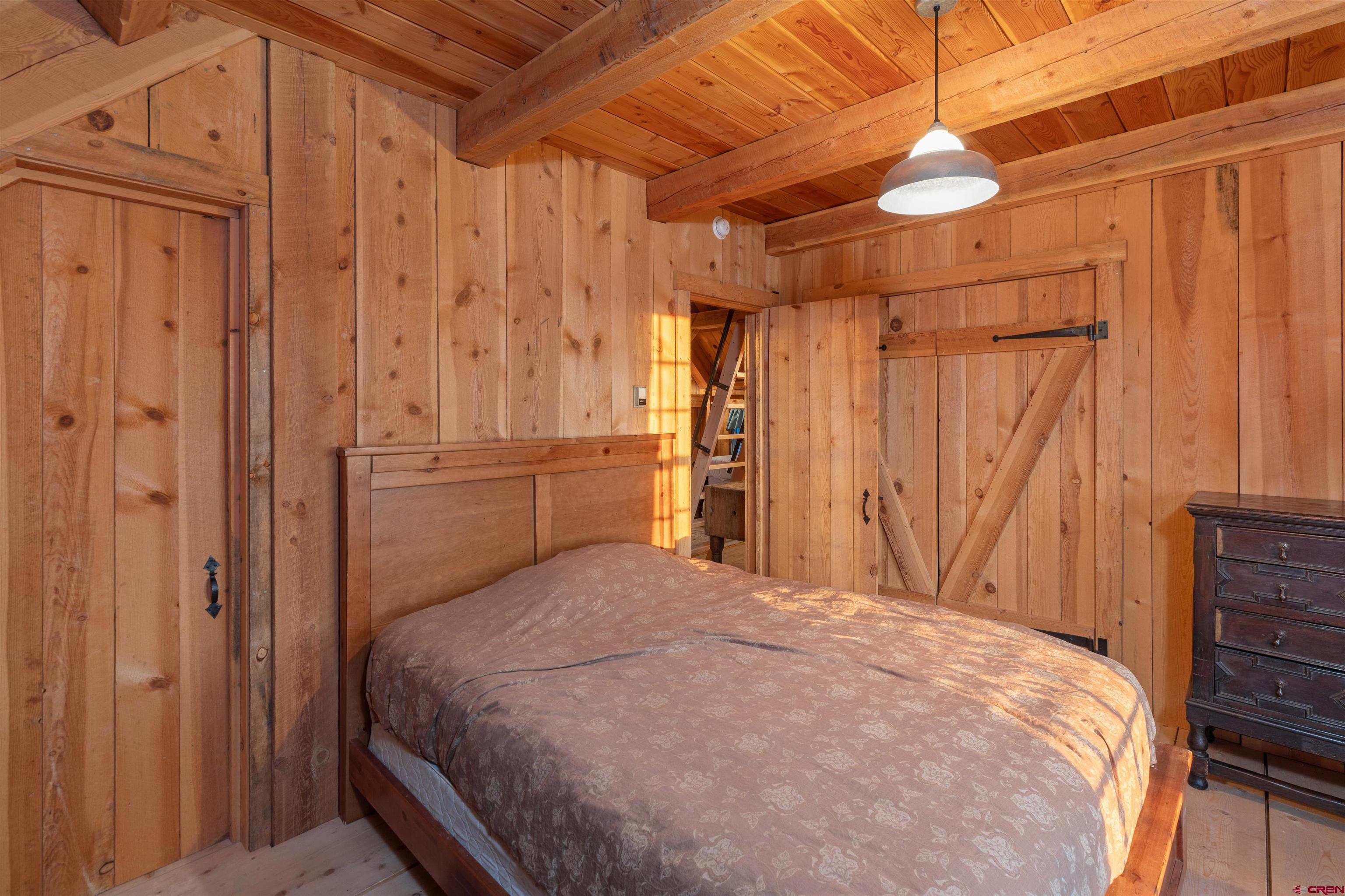 842 Ranch Road Ridgway, CO 81432 - Photo 26 of 35 a bedroom with a bed and a table