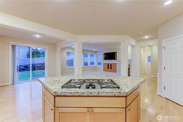 a kitchen with stainless steel appliances granite countertop a stove and a sink
