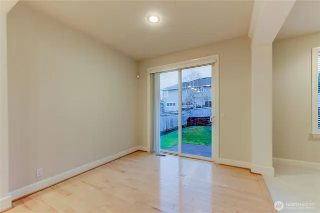 an empty room with closet and a window