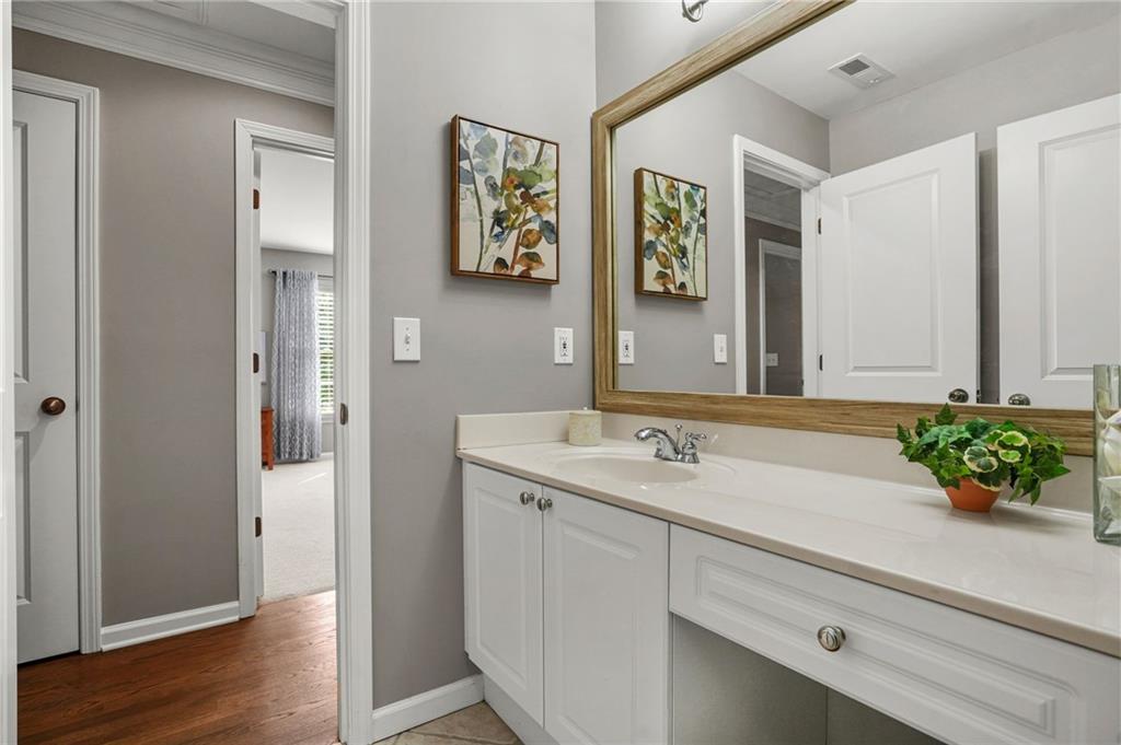 509 Crested Hawk Ridge Canton, GA 30114 - Photo 47 of 89 a bathroom with a granite countertop sink and a mirror