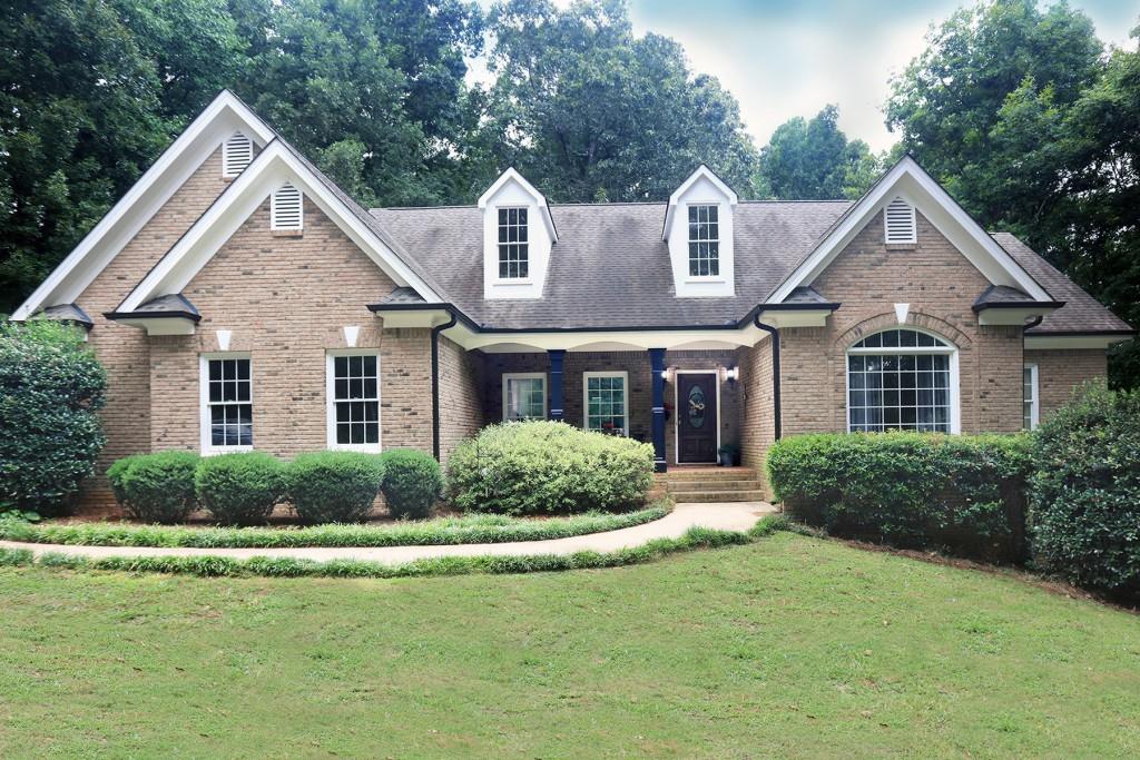 4110 Martin Road Cumming, GA 30028 - Photo 1 of 1 a front view of a house with a yard