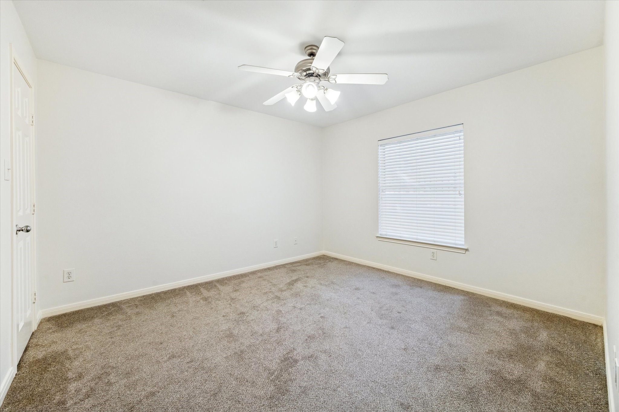 1626 Genesee Street Houston, TX 77006 - Photo 18 of 22 an empty room with a chandelier fan and windows