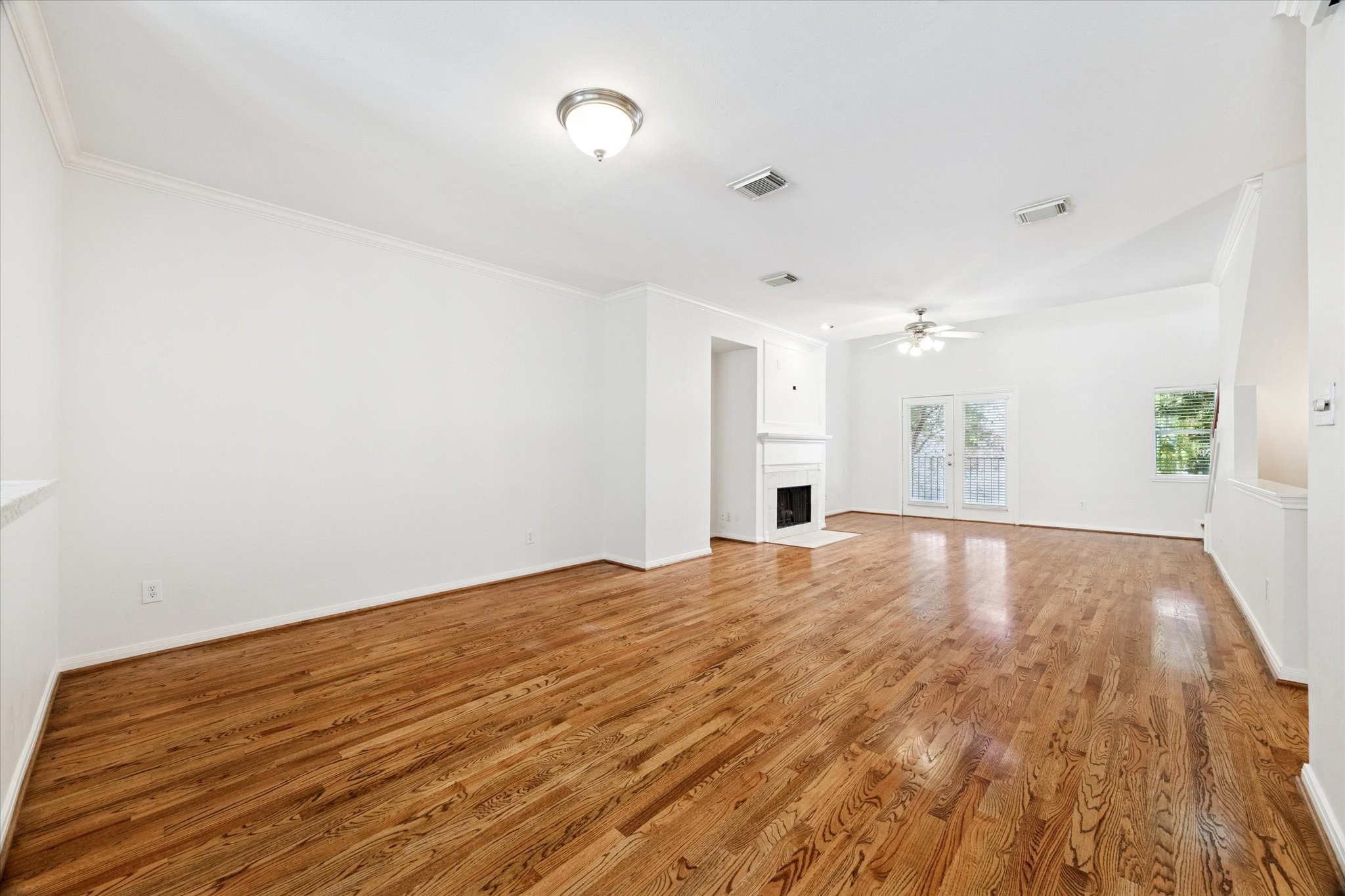 1626 Genesee Street Houston, TX 77006 - Photo 4 of 22 a view of empty room with wooden floor and fan