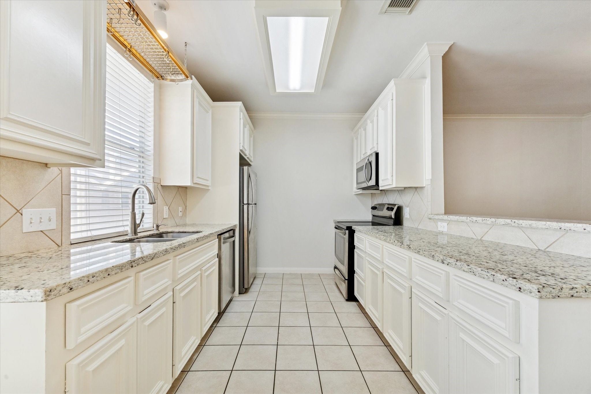 1626 Genesee Street Houston, TX 77006 - Photo 8 of 22 a large white kitchen with granite countertop a sink