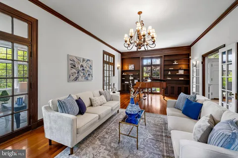 a living room with furniture a coffee table and a flat screen tv