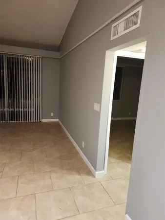 a view of an empty room with windows