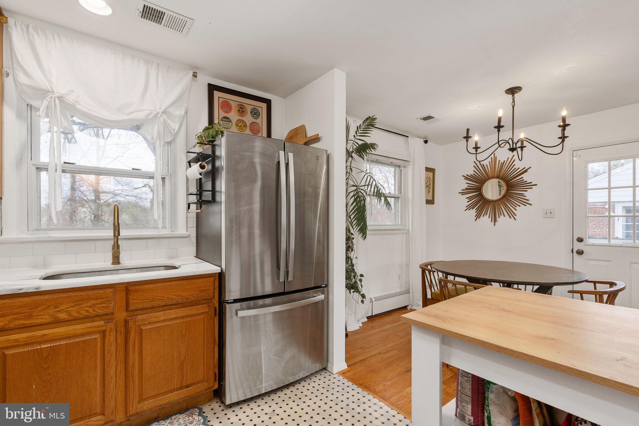 6714 Ruskin Street Springfield, VA 22150 - Photo 22 of 63 a kitchen with stainless steel appliances granite countertop a refrigerator a sink dishwasher a stove with white cabinets and wooden floor