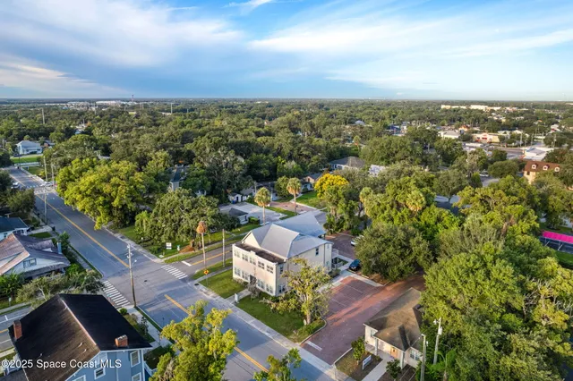 an aerial view of a house with a yard