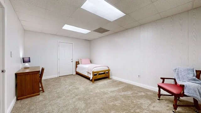 a bedroom with a bed and a chair