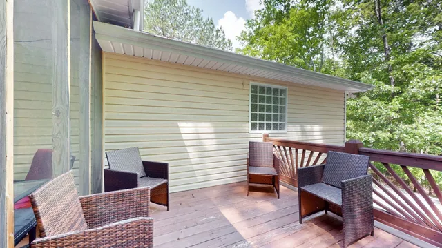 a view of a roof deck with wooden floor and fence