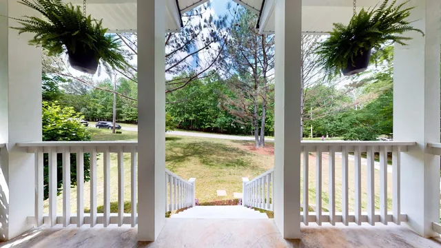 a view of a balcony with a tree