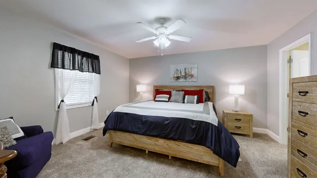 a bedroom with a bed and a chandelier