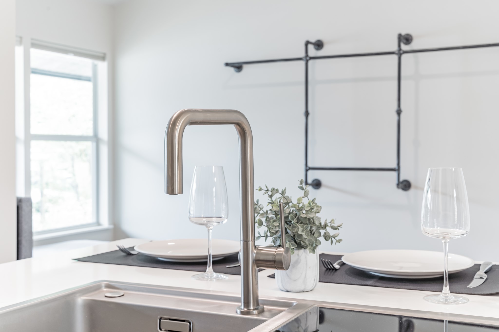 2201 Leon Street Austin, TX 78705 - Photo 19 of 30 A modern kitchen island features a sleek faucet and stainless steel sink.
