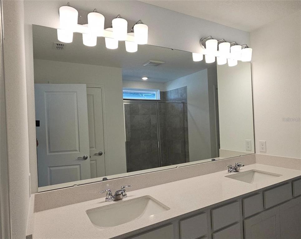 304 Woodsage Place Lake Alfred, FL 33850 - Photo 18 of 30 a bathroom with a sink and a mirror