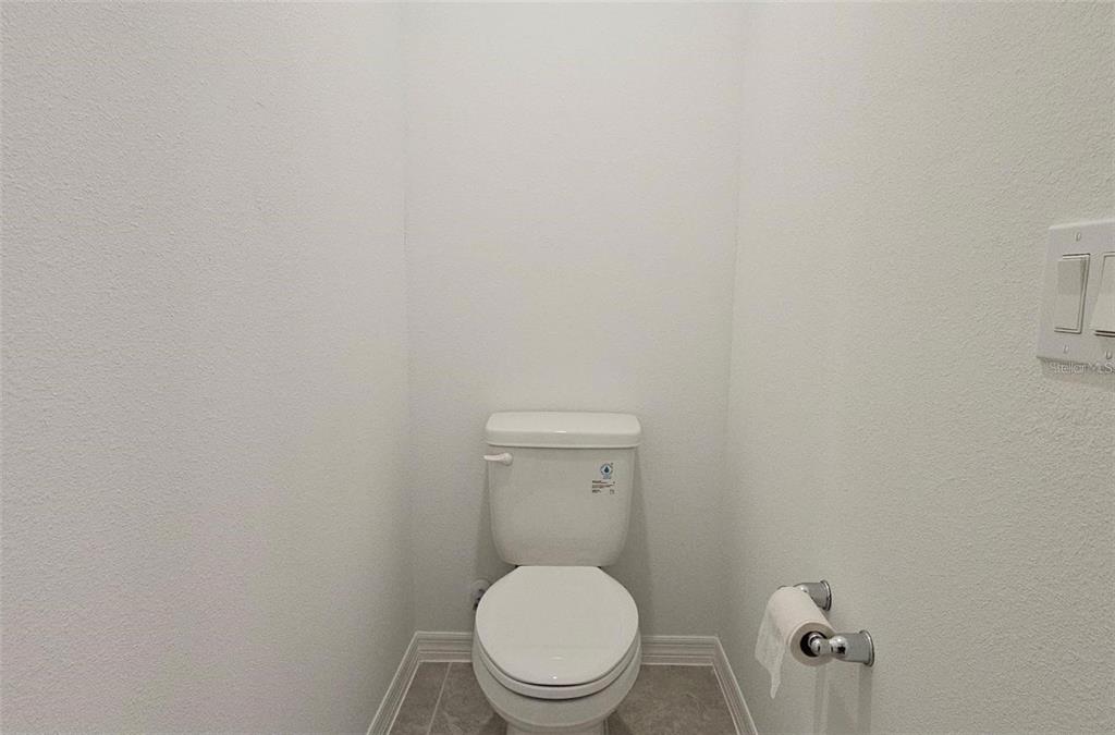 304 Woodsage Place Lake Alfred, FL 33850 - Photo 21 of 30 a white toilet sitting in a bathroom