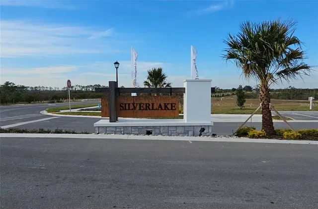 a sign board on the side of a street