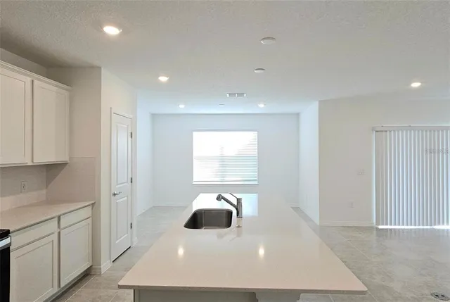 a view of a kitchen with a sink and dishwasher with wooden floor