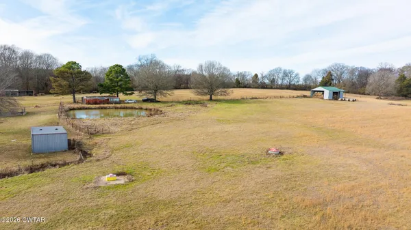 a view of a swimming pool and a yard