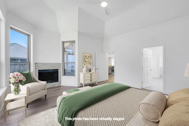 a bedroom with a bed couches and a fireplace