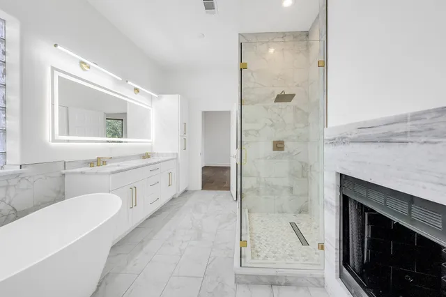 a spacious bathroom with a shower sink and mirror