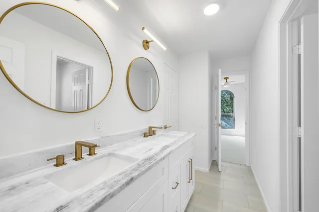 a bathroom with a double vanity sink and a mirror