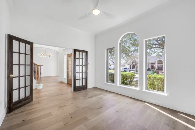 wooden floor in an empty room with a window
