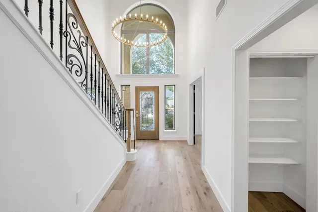 a view of entryway and hall with wooden floor