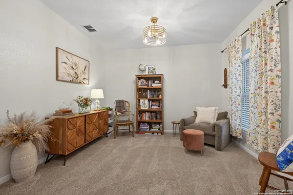 a living room with furniture and a baby crib