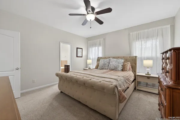 a bedroom with a bed chandelier and a window