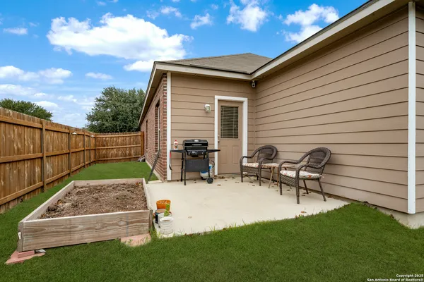 a view of backyard with sitting area
