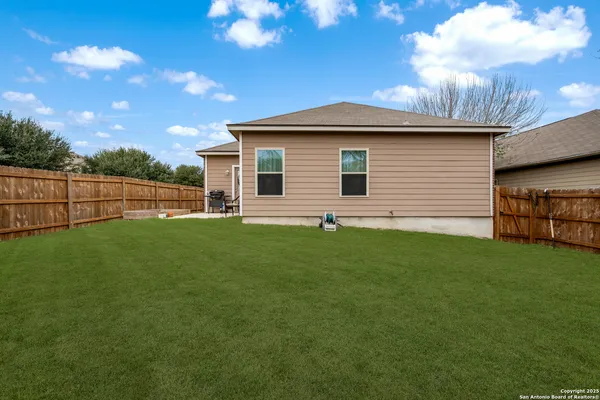 a view of a backyard with plants and a backyard