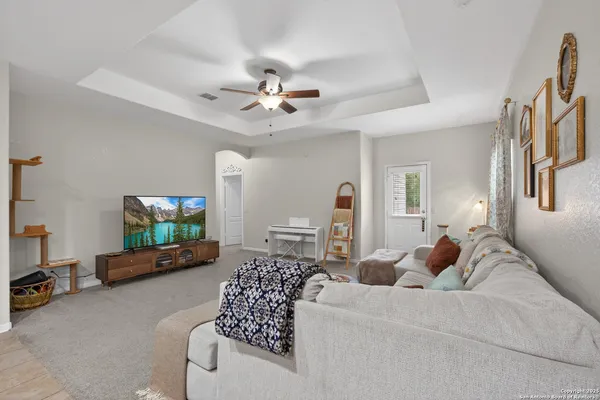 a living room with furniture a chandelier and a couch