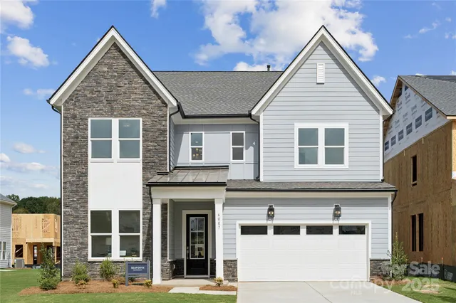 a front view of a house with large windows